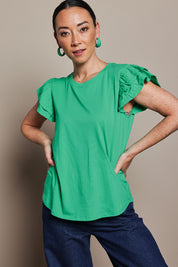 Model Katie wearing size 10 of the Ruffle Sleeve Top in colour Mint (Green), from the front, cropped image