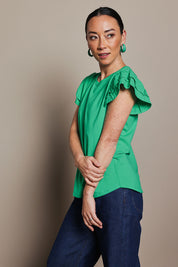 Model Katie wearing size 10 of the Ruffle Sleeve Top in colour Mint (Green), from the front, cropped image