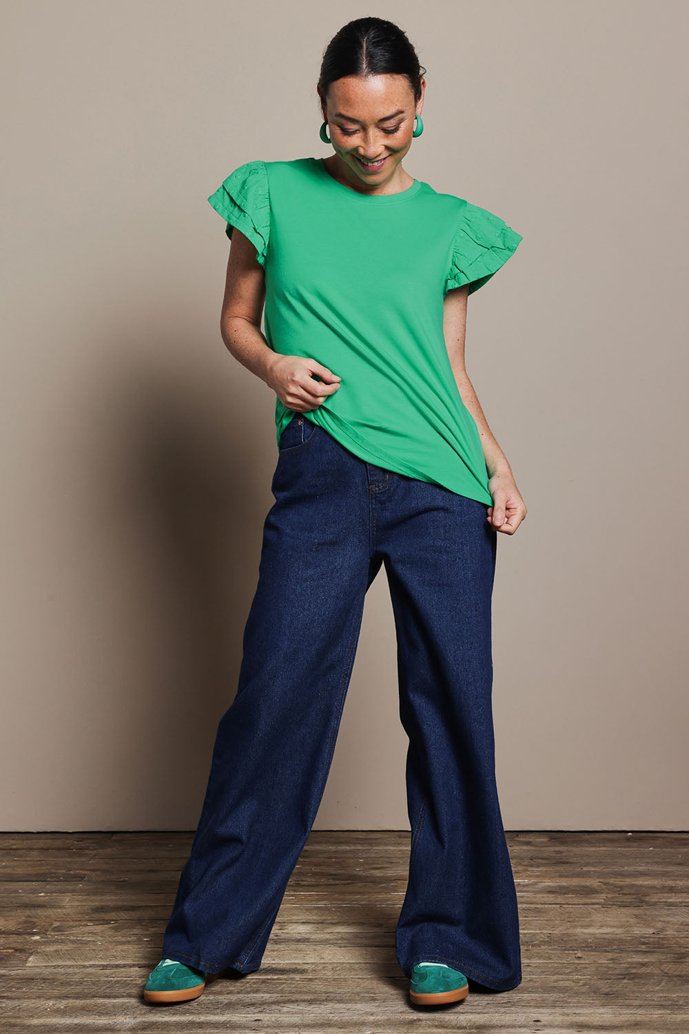 Model Katie wearing size 10 of the Ruffle Sleeve Top in colour Mint (Green), from the front, showing the whole outfit
