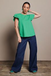 Model Katie wearing size 10 of the Ruffle Sleeve Top in colour Mint (Green), from the front, showing the whole outfit