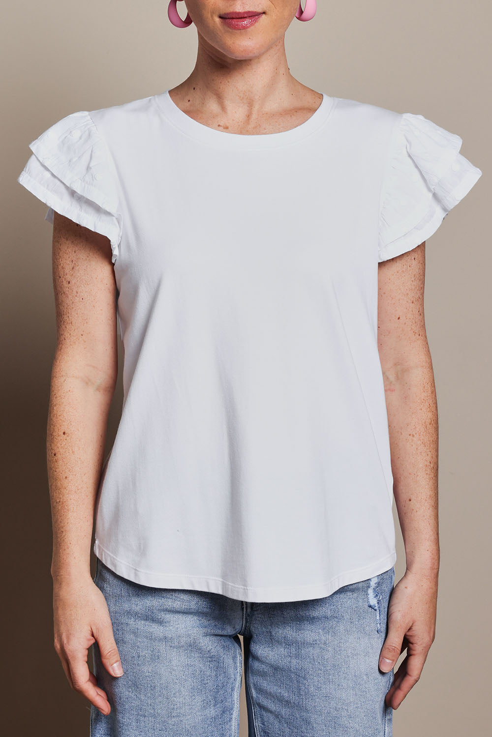 Model Katie wearing size 10 of the Ruffle Sleeve Top in colour White (White), from the front, cropped image