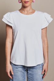 Model Katie wearing size 10 of the Ruffle Sleeve Top in colour White (White), from the front, cropped image