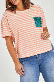Model Monique wearing size 14 of the Sequin Pocket Tee in colour Sequins, from the front, cropped image