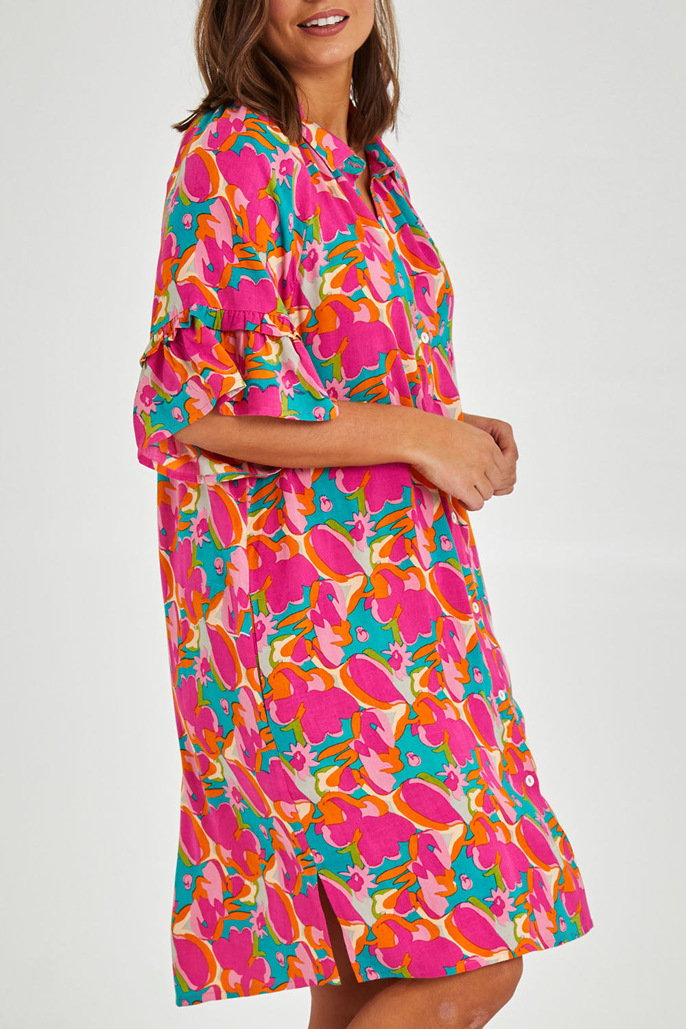 Model Monique wearing size 14 of the Button Through Shirt Dress in colour Boldfloral (Pink), from the front, cropped image