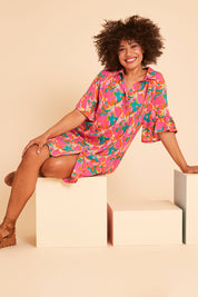 Model Olivia wearing size 10 of the Button Through Shirt Dress in colour Boldfloral (Pink), from the front, showing the whole outfit