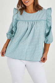Model Monique wearing size 14 of the Gingham Poet Top in colour Blugingham (Blue), from the front, cropped image