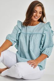 Model Monique wearing size 14 of the Gingham Poet Top in colour Blugingham (Blue), from the front, cropped image