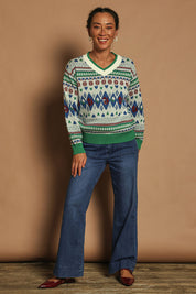 Model Katie wearing size S of the V Neck Foxy Jumper in colour Foxygreen (Green), from the front, showing the whole outfit