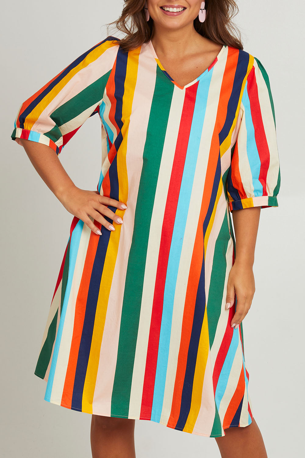 Model Monique wearing size 14 of the V Neck Flounce Sleeve Dress in colour Striped (Blue), from the front, cropped image
