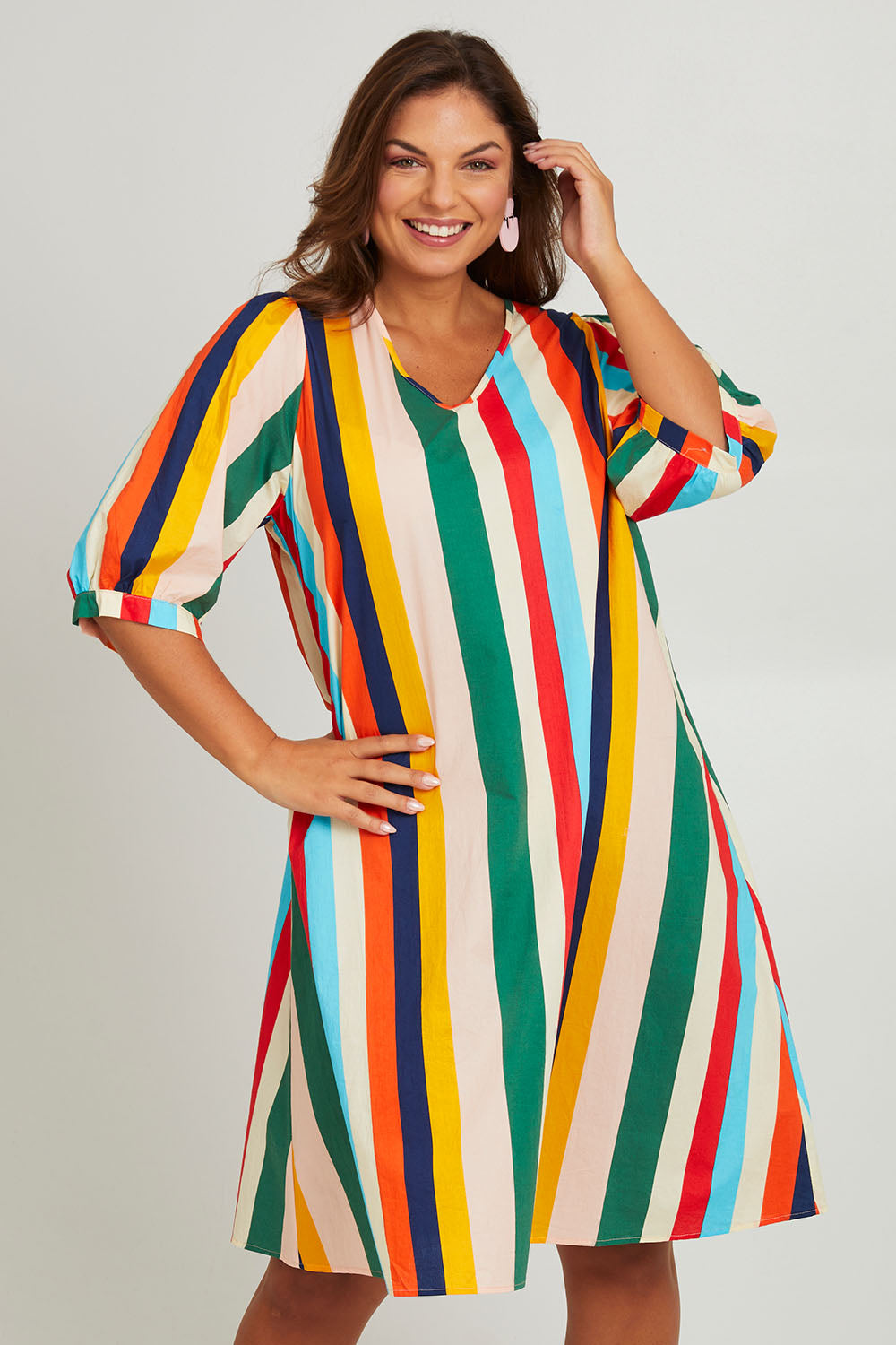 Model Monique wearing size 14 of the V Neck Flounce Sleeve Dress in colour Striped (Blue), from the front, cropped image