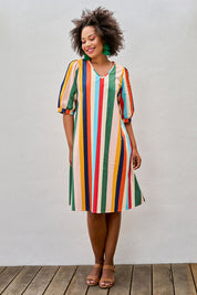 Model Olivia wearing size 10 of the V Neck Flounce Sleeve Dress in colour Striped (Blue), from the front, showing the whole outfit
