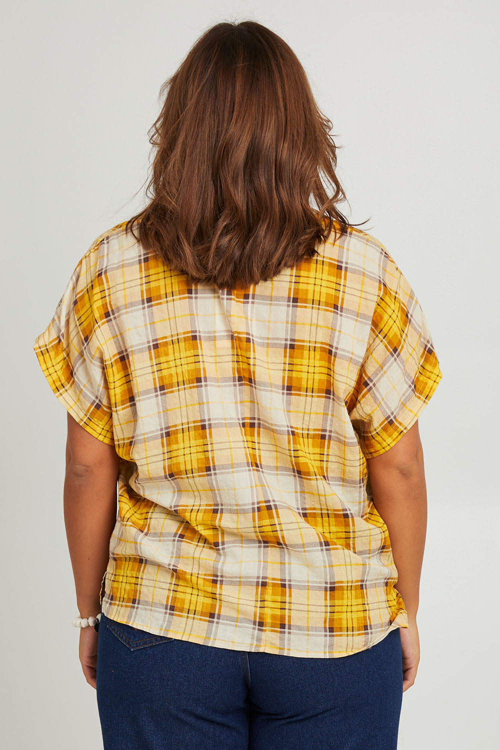 Model Monique wearing size 14 of the V Neck Check Top in colour Citruschec, from the back