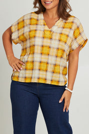 Model Monique wearing size 14 of the V Neck Check Top in colour Citruschec, from the front, cropped image