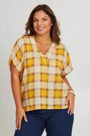 Model Monique wearing size 14 of the V Neck Check Top in colour Citruschec, from the front, cropped image