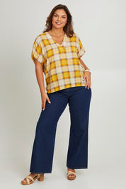 Model Monique wearing size 14 of the V Neck Check Top in colour Citruschec, from the front, showing the whole outfit