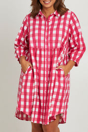 Model Monique wearing size 14 of the Printed Waist Detail Dress in colour Berrycheck (Pink), from the front, cropped image