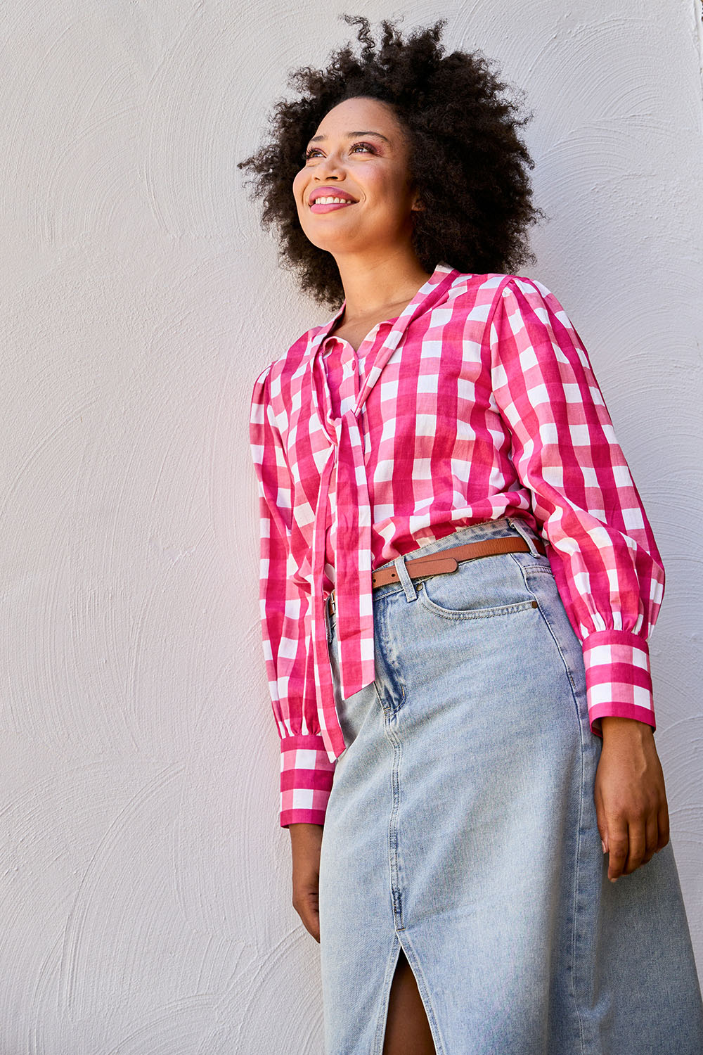 Model Olivia wearing size 10 of the Printed Tie Neck Blouse in colour Berrycheck (Pink), from the front, showing the whole outfit