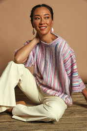 Model Katie wearing size S of the Striped Oversize Sweater in colour Candyfloss (Pink), from the front, showing the whole outfit