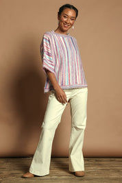 Model Katie wearing size S of the Striped Oversize Sweater in colour Candyfloss (Pink), from the front, showing the whole outfit