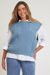 Model Chanel wearing the Cable Vest in colour Bluehaze (Blue), from the front, cropped image