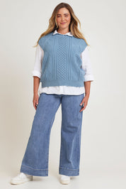 Model Chanel wearing the Cable Vest in colour Bluehaze (Blue), from the front, showing the whole outfit