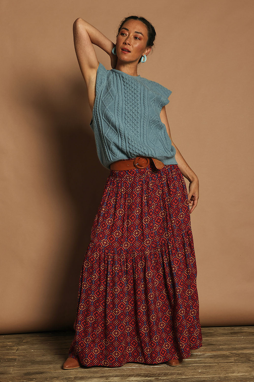 Model Katie wearing the Cable Vest in colour Bluehaze (Blue), from the front, showing the whole outfit
