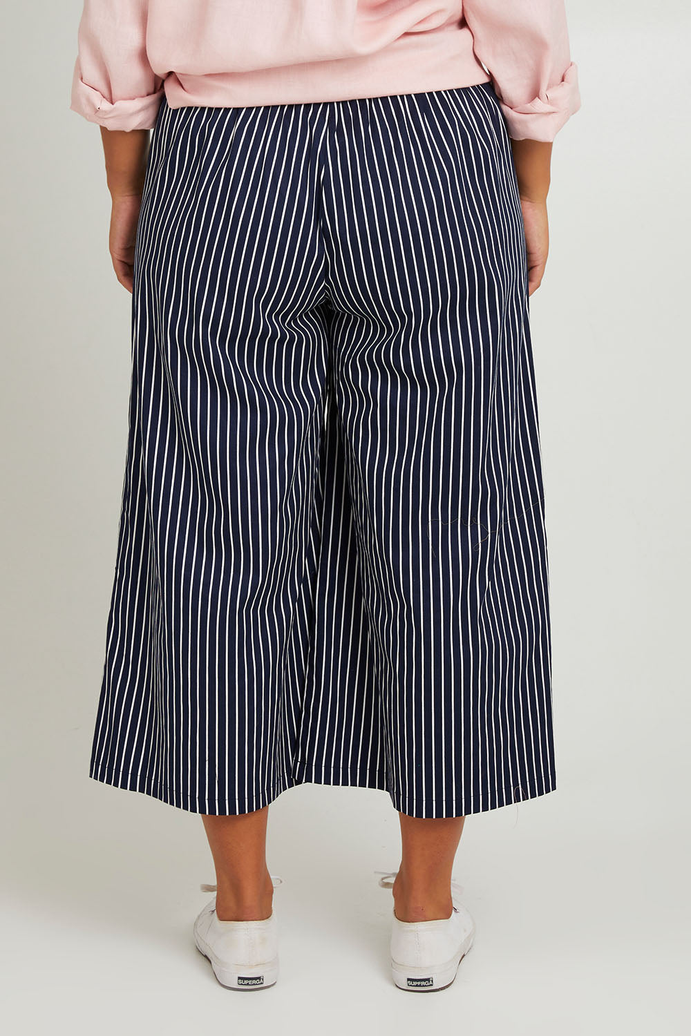 Model Monique wearing size 14 of the Striped Wide Leg Pant in colour Navywhite (Blue), from the back