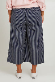 Model Monique wearing size 14 of the Striped Wide Leg Pant in colour Navywhite (Blue), from the back