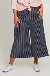 Model Monique wearing size 14 of the Striped Wide Leg Pant in colour Navywhite (Blue), from the front, cropped image
