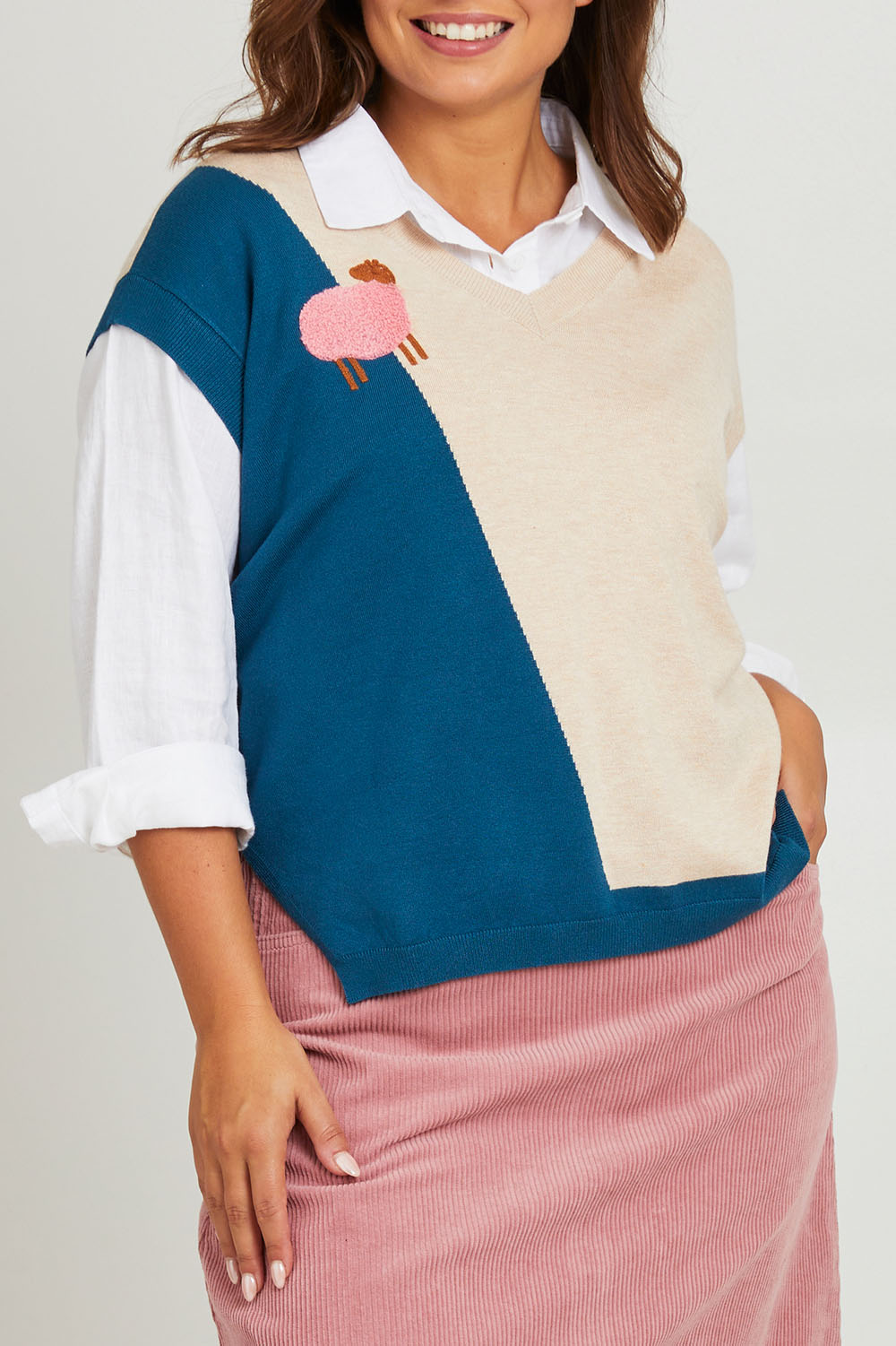 Model Monique wearing size L of the Sheepish Vest in colour Sheepish, from the front, cropped image