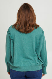 Model Monique wearing size 14 of the Heart Cotton Sweater in colour Hearts (Green), from the back