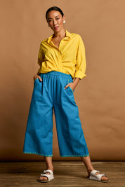 Model Katie wearing size 10 of the Crochet Pocket Cotton Pant in colour Oceanblue (Blue), from the front, showing the whole outfit