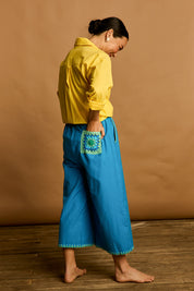 Model Katie wearing size 10 of the Crochet Pocket Cotton Pant in colour Oceanblue (Blue), from the front, showing the whole outfit