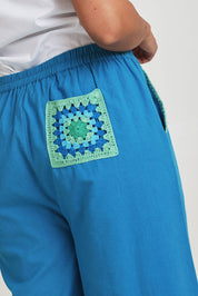 Model Terri-Leigh wearing size 14 of the Crochet Pocket Cotton Pant in colour Oceanblue (Blue), from the front, cropped image
