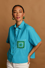 Model Katie wearing size 10 of the Crochet Pocket Cotton Shirt in colour Skyblue (Blue), from the front, showing the whole outfit