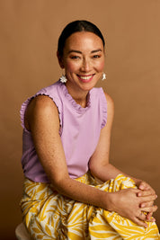 Model Katie wearing size 10 of the Cotton Frill Tank in colour Lilac (Purple), from the front, showing the whole outfit