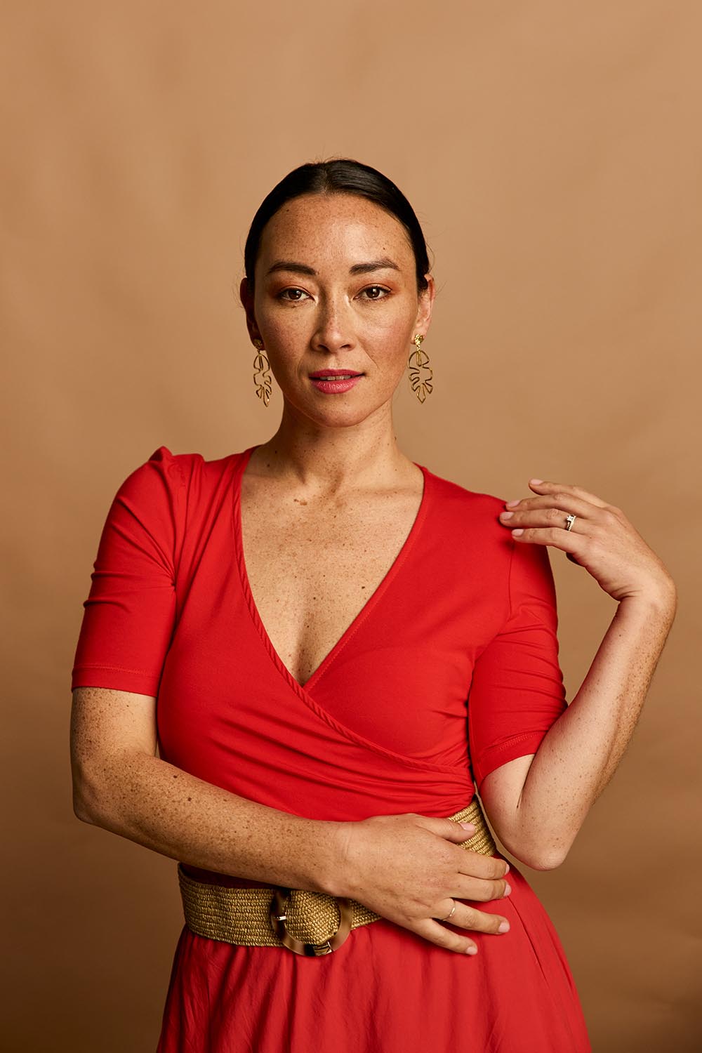 Model Katie wearing size 10 of the Bamboo Wrap Top in colour Cherry (Red), from the front, showing the whole outfit