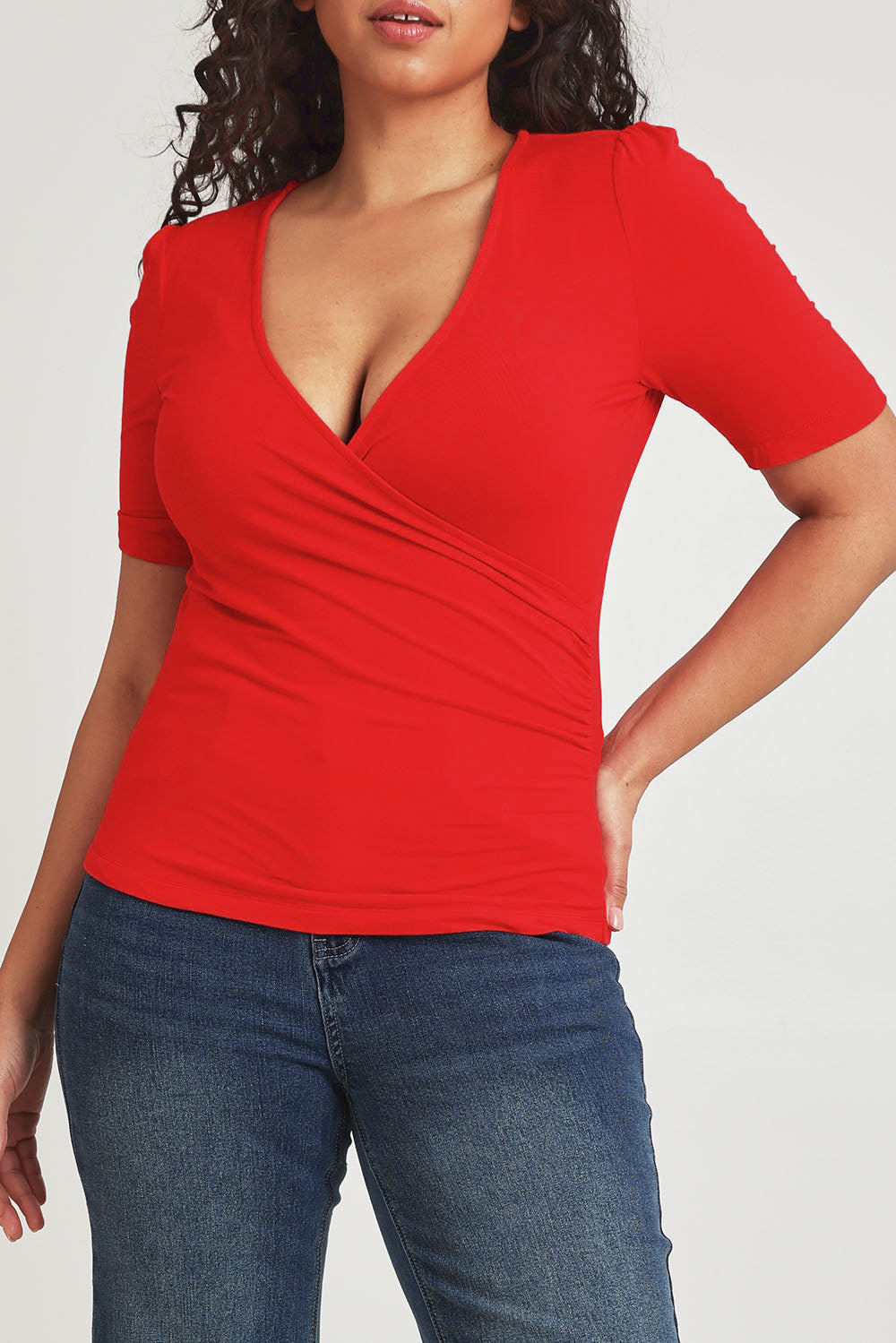Model Terri-Leigh wearing size 14 of the Bamboo Wrap Top in colour Cherry (Red), from the front, cropped image
