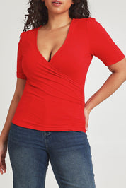 Model Terri-Leigh wearing size 14 of the Bamboo Wrap Top in colour Cherry (Red), from the front, cropped image