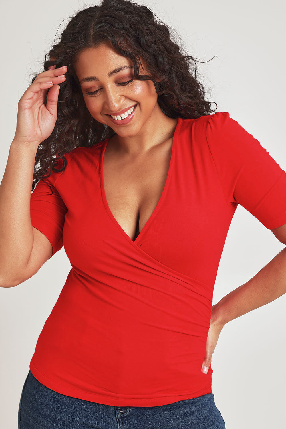Model Terri-Leigh wearing size 14 of the Bamboo Wrap Top in colour Cherry (Red), from the front, cropped image