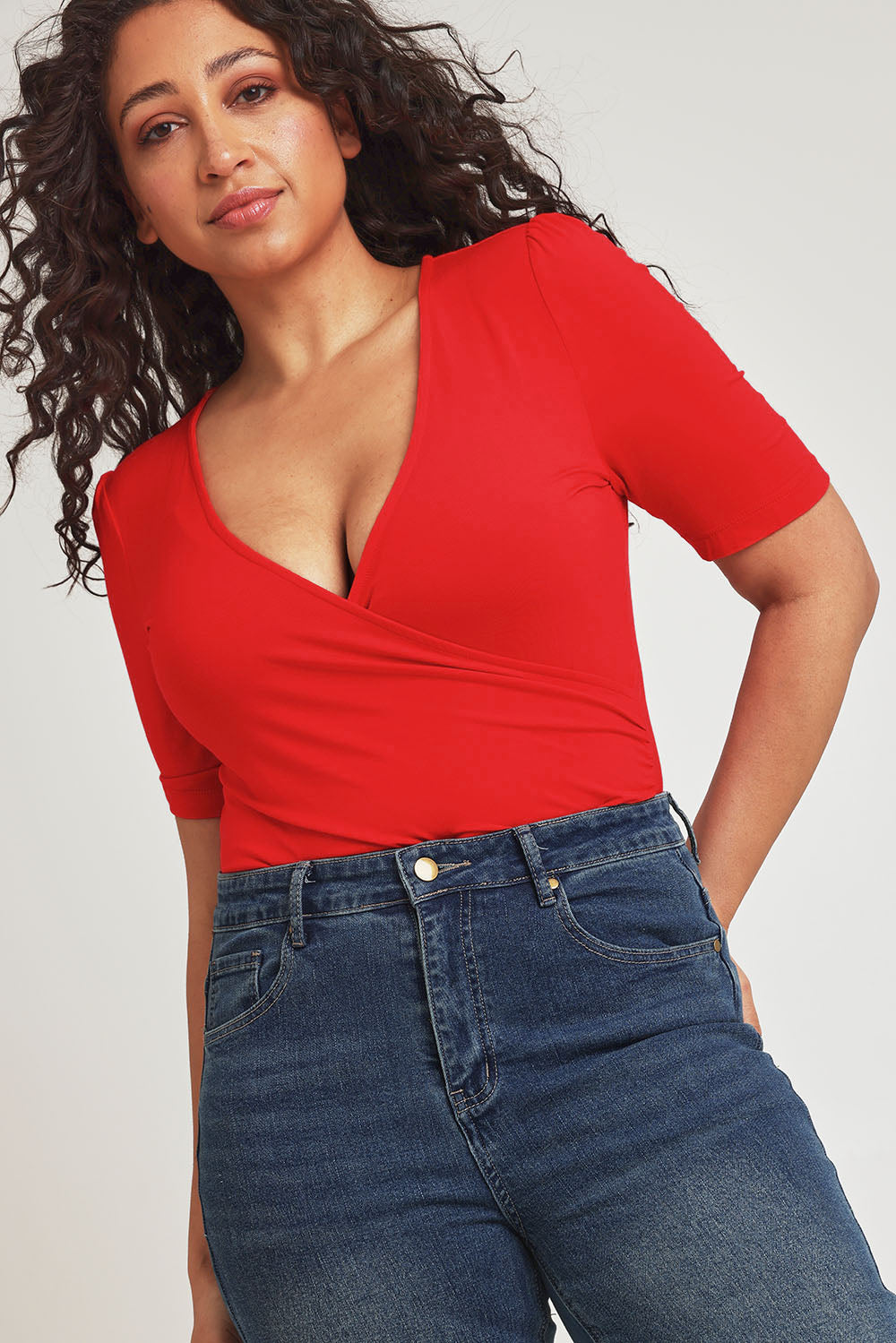 Model Terri-Leigh wearing size 14 of the Bamboo Wrap Top in colour Cherry (Red), from the front, cropped image