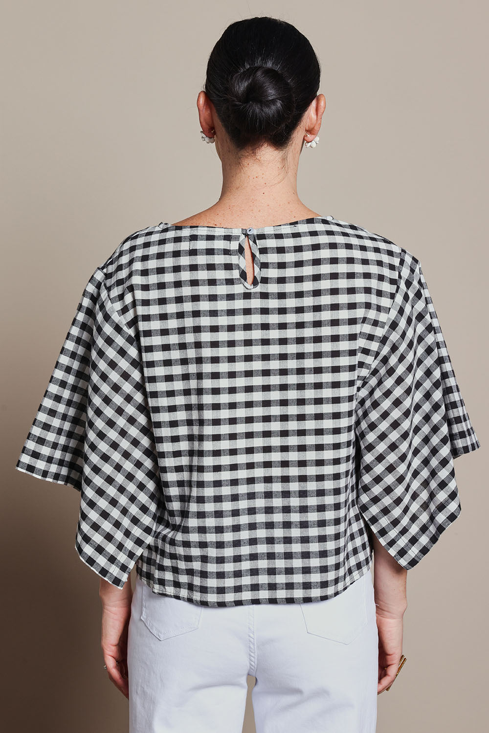 Model Katie wearing size 10 of the Yarn Dyed Cotton Wide Sleeve Top in colour Gingham (Black), from the back