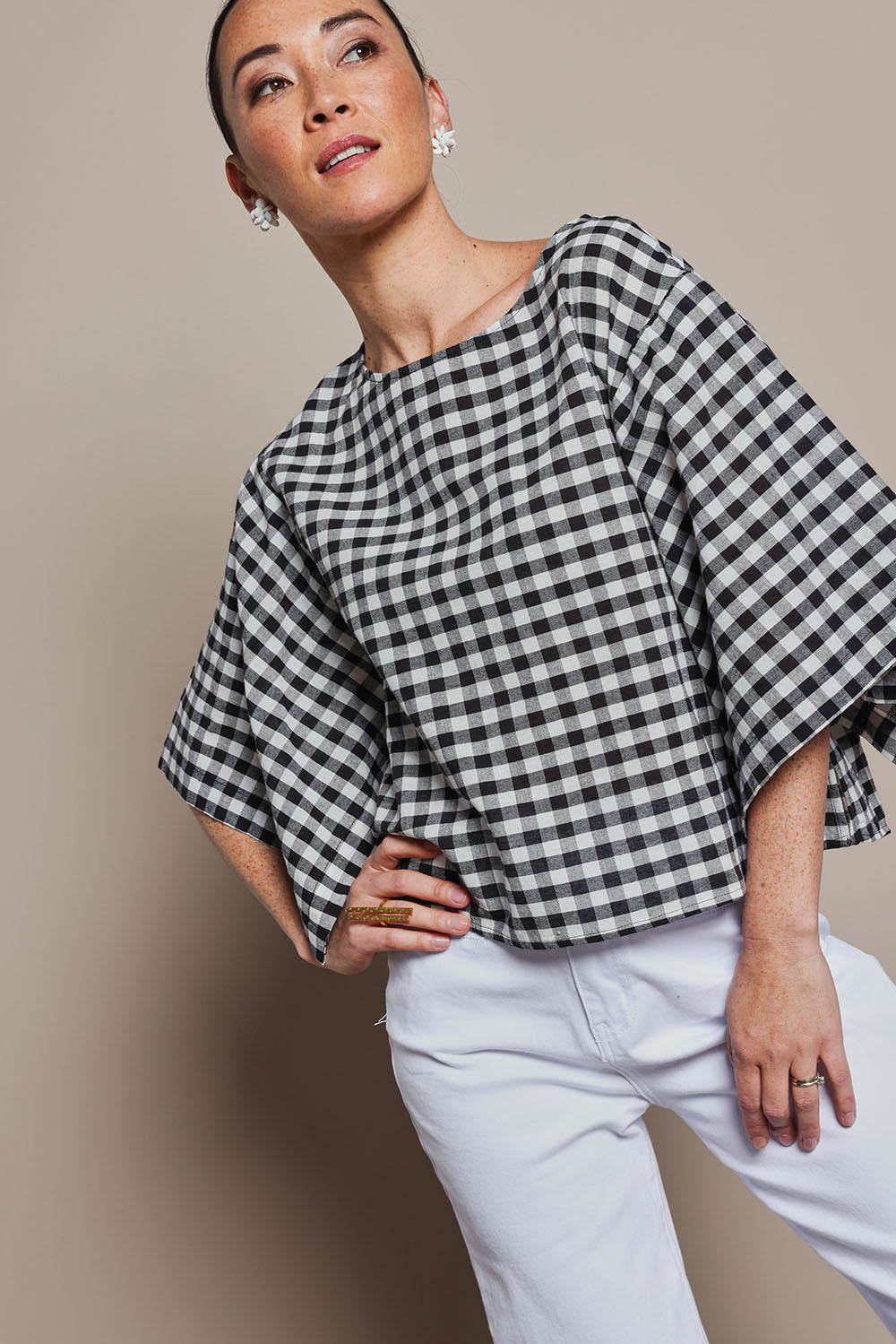 Model Katie wearing size 10 of the Yarn Dyed Cotton Wide Sleeve Top in colour Gingham (Black), from the front, cropped image