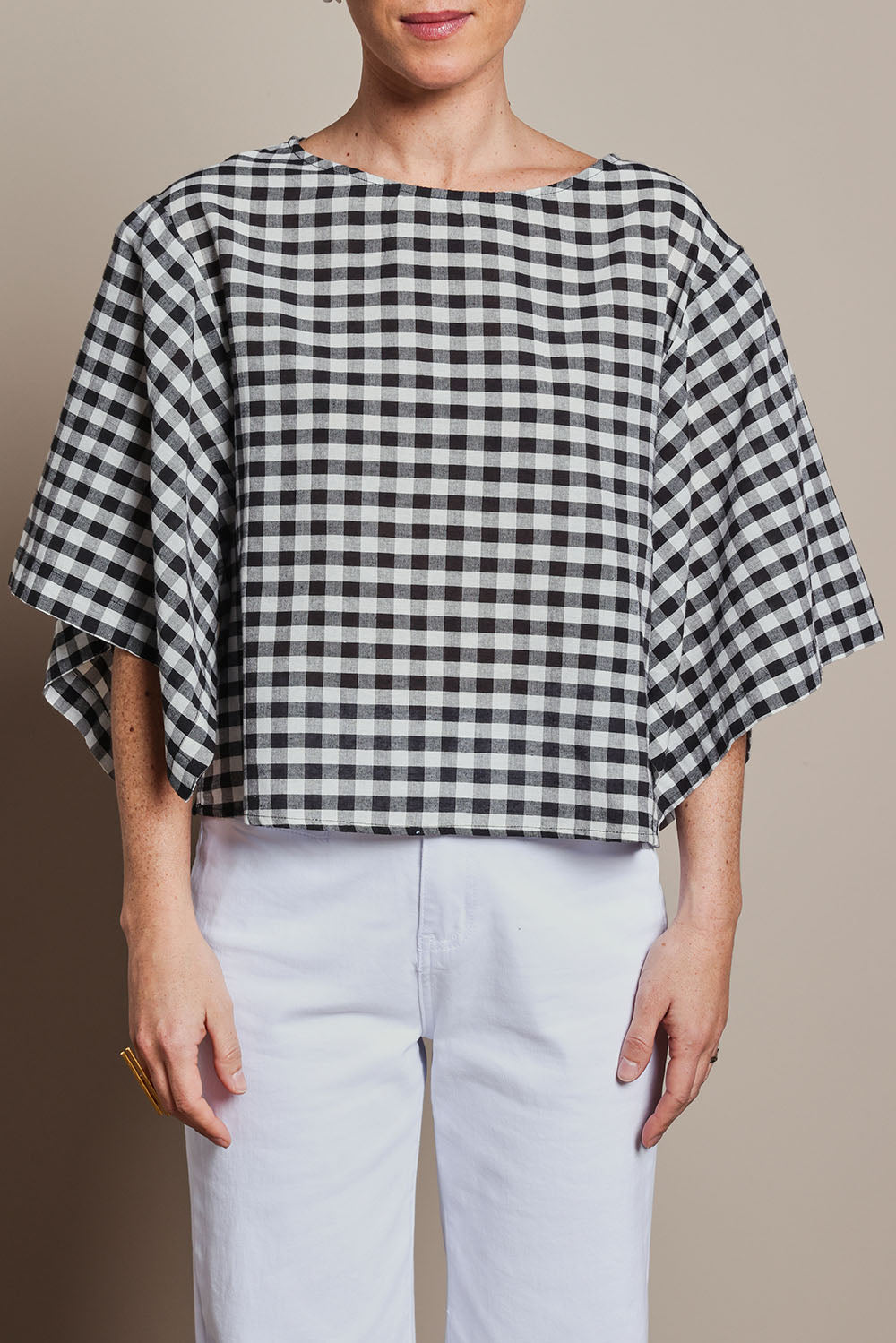 Model Katie wearing size 10 of the Yarn Dyed Cotton Wide Sleeve Top in colour Gingham (Black), from the front, cropped image