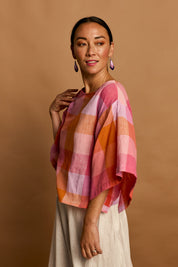 Model Katie wearing size 10 of the Yarn Dyed Cotton Wide Sleeve Top in colour Sherbet (Pink), from the front, showing the whole outfit