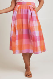 Model Terri-Leigh wearing size 14 of the Yarn Dyed Cotton Pleat Front Skirt in colour Sherbet (Pink), from the front, cropped image