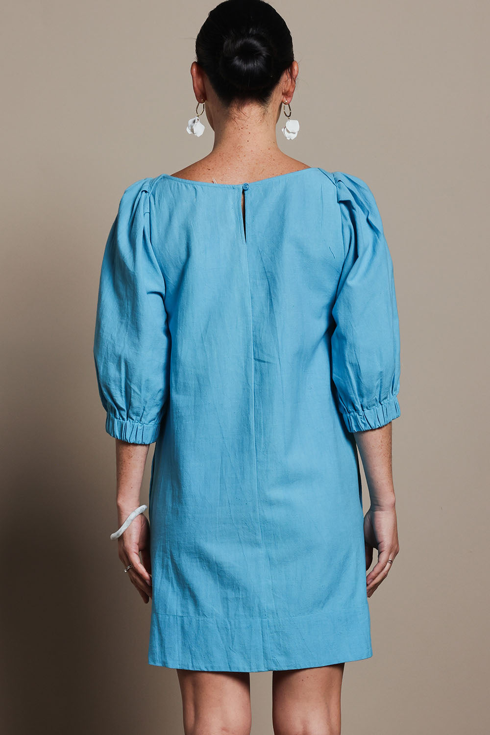 Model Katie wearing size 10 of the Puff Sleeve Cotton Dress in colour Lightblue (Blue), from the back