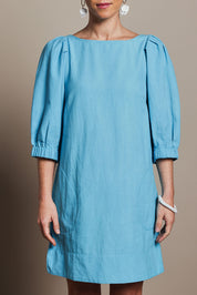 Model Katie wearing size 10 of the Puff Sleeve Cotton Dress in colour Lightblue (Blue), from the front, cropped image