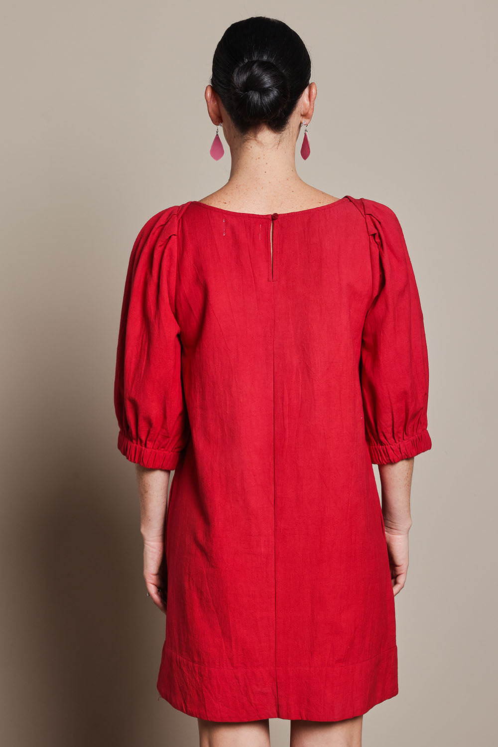 Model Katie wearing size 10 of the Puff Sleeve Cotton Dress in colour Ribbonred (Red), from the back