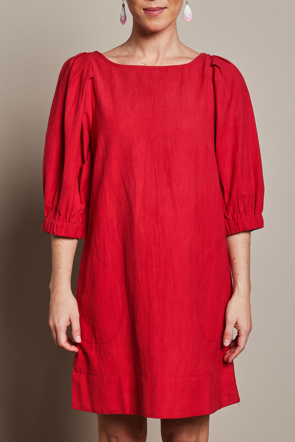 Model Katie wearing size 10 of the Puff Sleeve Cotton Dress in colour Ribbonred (Red), from the front, cropped image